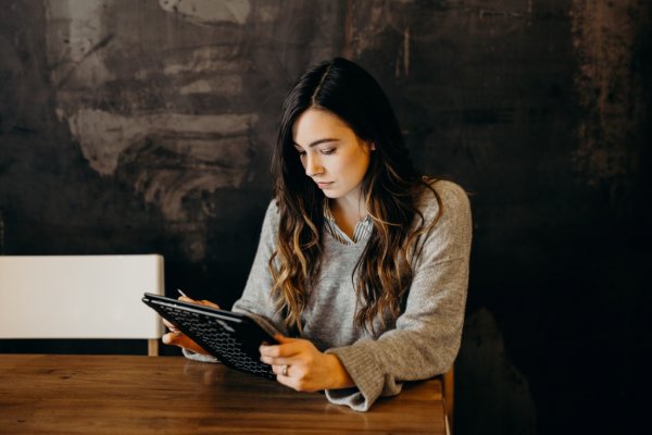 person sitting down looking over statements 